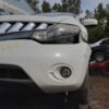 A white car that has been smashed in the front.