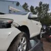 A white car that has been smashed in the back of it.