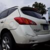 A white car with some damage on the back
