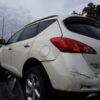 A white car that has been hit by a truck.