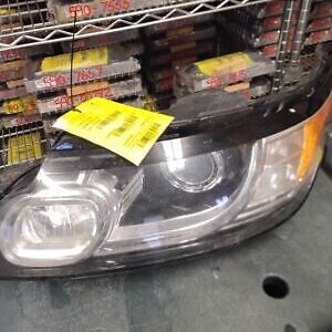 A car headlight sitting on top of a shelf.