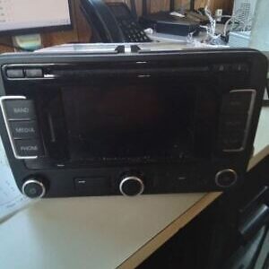 A black and silver radio sitting on top of a table.