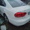 A white car that has been smashed in the back.