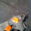 A blurry picture of an orange sign on the side of a road.