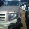 A silver truck parked in the middle of a lot.