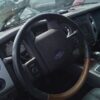 A steering wheel and dashboard of an suv.