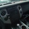 A car dashboard with the center console turned on.