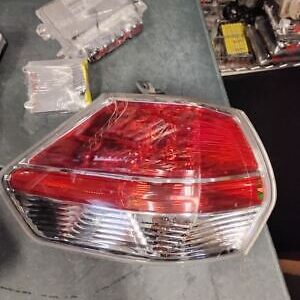 A red and clear tail light sitting on top of a table.