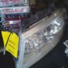 A car headlight with a yellow tag on it.