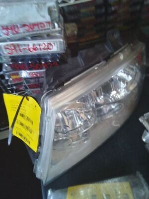 A car headlight with a yellow tag on it.