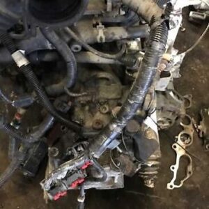 A car engine with some parts missing and a few other things