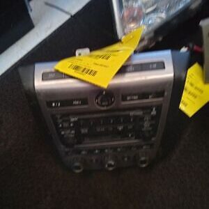 A radio with two yellow tags on it.