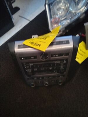 A radio with two yellow tags on it.