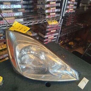 A silver car headlight sitting on top of a table.