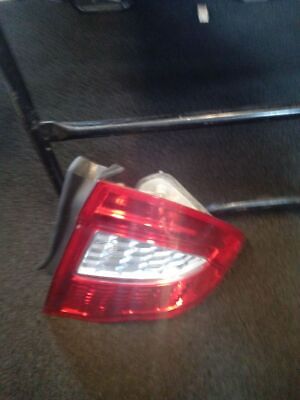 A car 's tail light is broken and sitting on the floor.