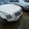 A white car is parked in the mud