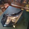 A car headlight that is broken on the table.
