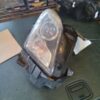 A car headlight sitting on top of the floor.