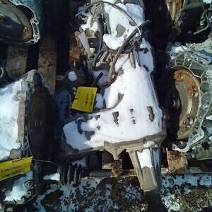 A pile of old parts that are in the snow.