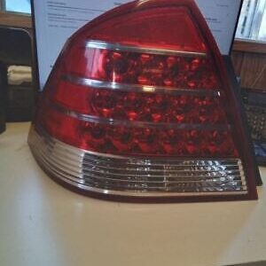 A red and white car tail light on top of a table.