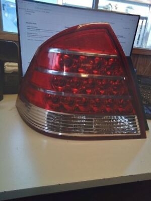 A red and white car tail light on top of a table.