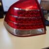 A red and white car tail light on top of a table.