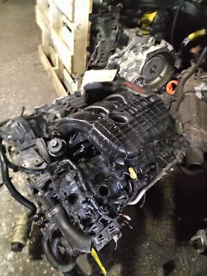 A car engine that is sitting on the floor.