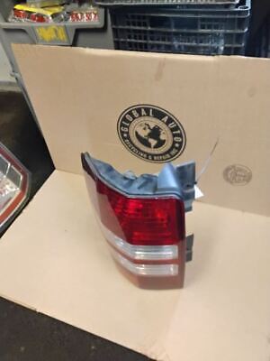 A red and white tail light sitting on top of a box.