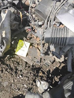 A pile of debris on the ground next to a car.