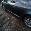 A car that is sitting in the dirt.