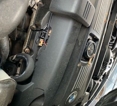 A close up of the engine cover on an older car