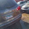 A car parked in the parking lot of a building.