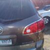 A car parked in the parking lot with its rear lights on.