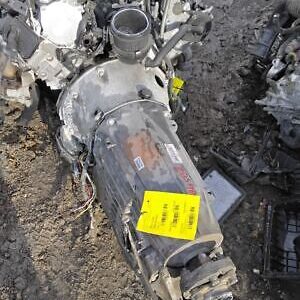 A car engine with a yellow tag on it.