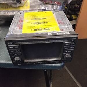 A black and silver car stereo sitting on top of a table.