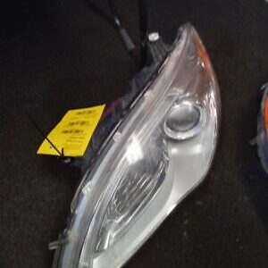 A car headlight with the lights on.