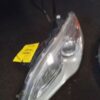 A car headlight with the price tag on it.