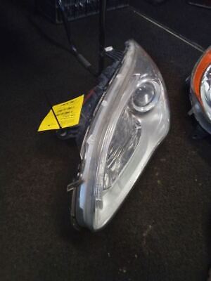 A car headlight with the yellow tag on it.