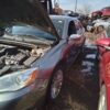 A car that has been broken down and is in the water.