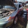 A car that has been broken down and is in the water.