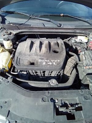 A car engine with the hood open.