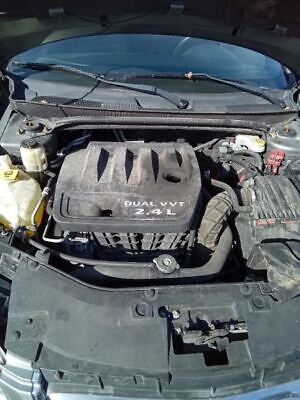 A car engine with the hood open.