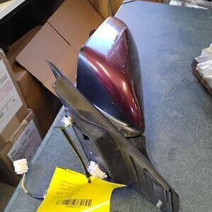 A red and black motorcycle helmet sitting on top of a table.