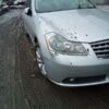 A silver car parked on the side of a road.