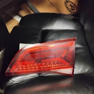 A red tail light sitting on top of a black leather couch.