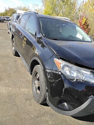 A black car that has been smashed in the road.