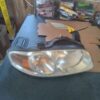 A car headlight with the hood up.