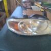 A car headlight is shown with the lights on.