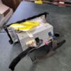 A broken tv with wires and other items on it.
