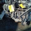 A car engine with some yellow tags on it